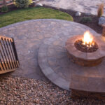Circular fire pit at dusk on a flagstone patio